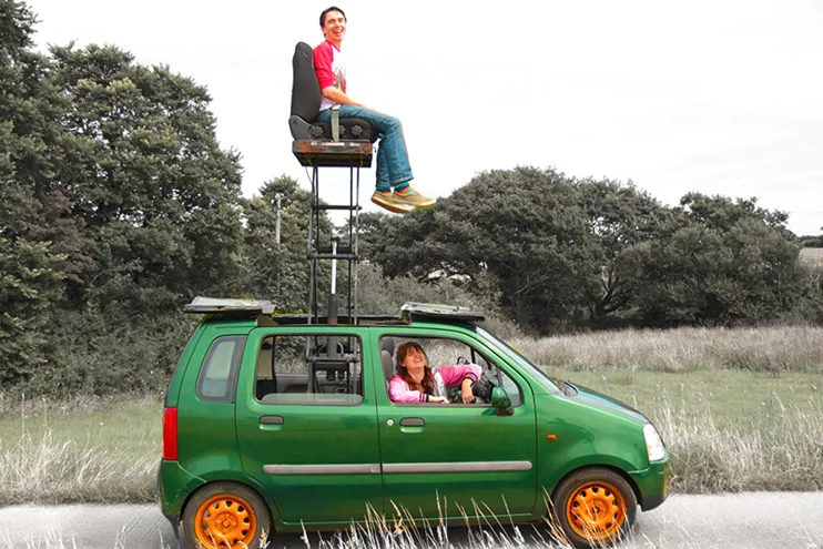 A person sitting on a chair on top of a car