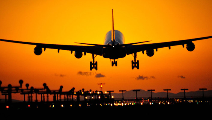 Aircraft flying in to the sunset